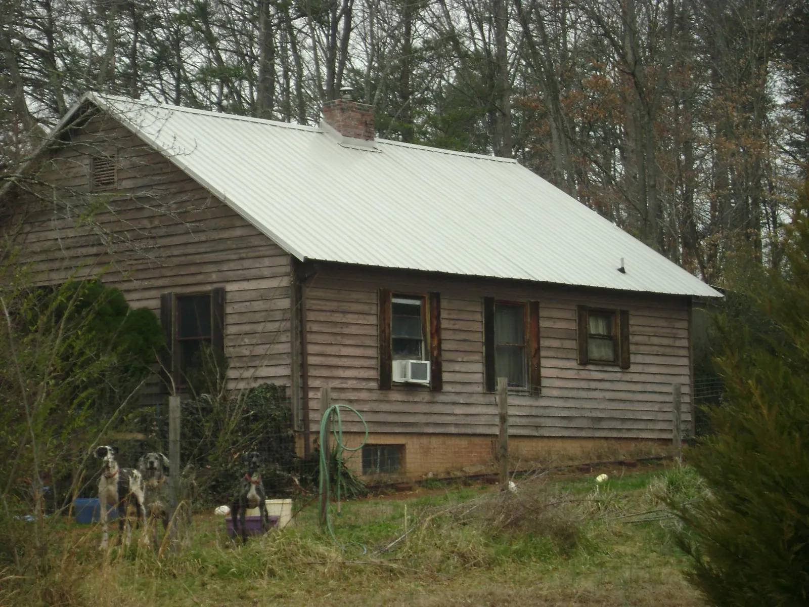 White metal roof on an old wood sided farmhouse, from a Metal Roof Installation job in Palmetto